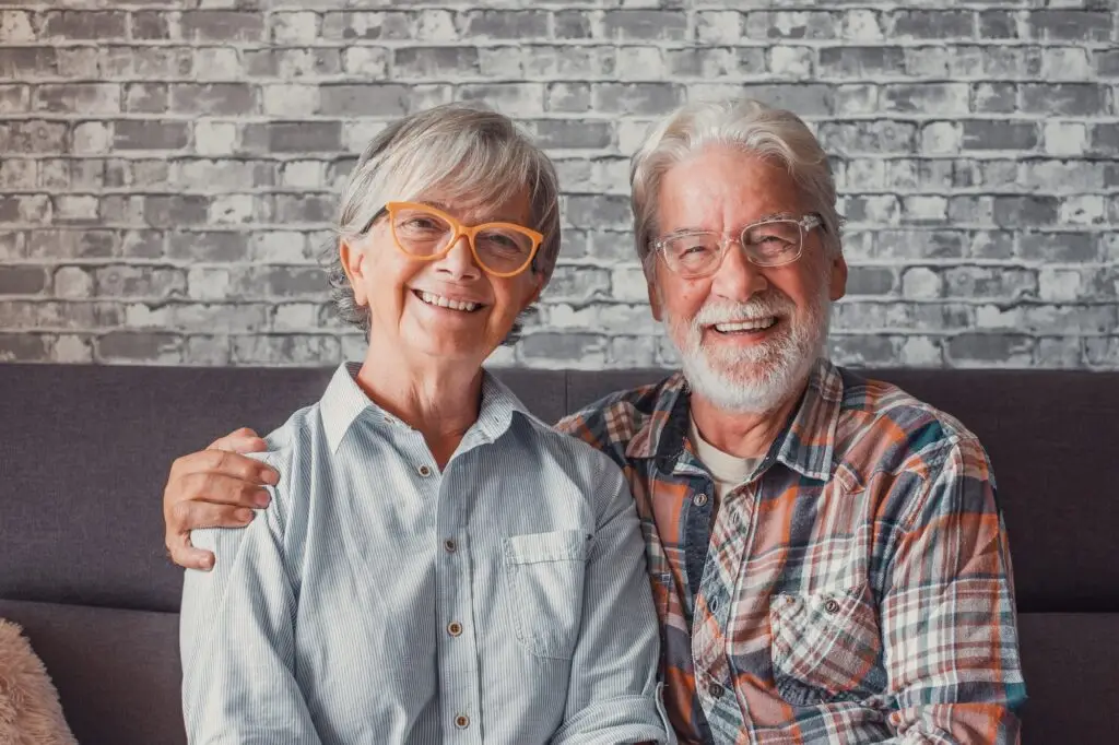 Portrait of couple of mature people wearing glasses and looking at the camera together.